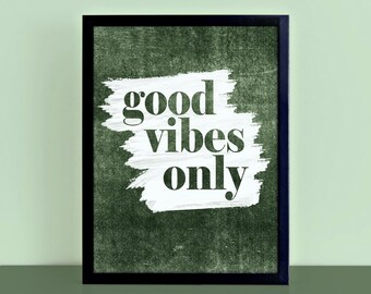 May include: A framed art print featuring the phrase "good vibes only" in a bold font. The white text is set against a white brushstroke on a dark green textured background, within a black frame.