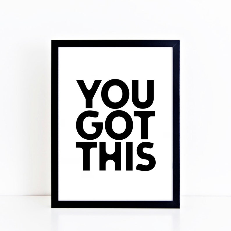 May include: A framed print with the words "YOU GOT THIS" in bold black letters on a white background. The frame is black. The print is a motivational piece.