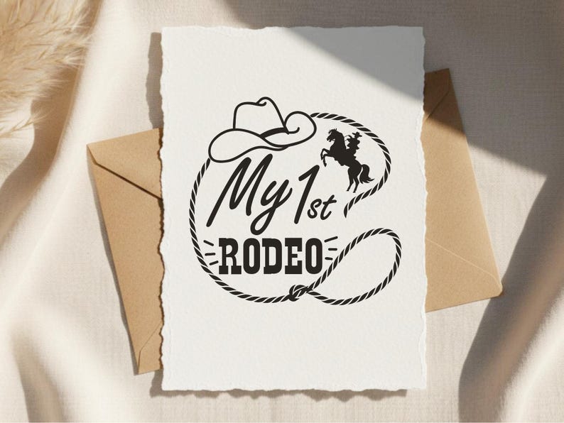 May include: A white card with the text "My 1st Rodeo" in a black, Western-style font, encircled by a rope design. A cowboy hat and a silhouette of a horse and rider are also featured.