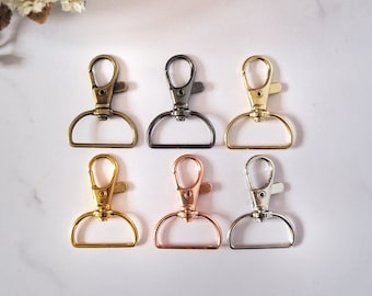May include: Six metal swivel clasps in different finishes: antique brass, gunmetal, gold, rose gold, and silver.