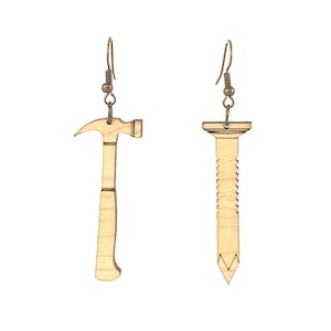 May include: A pair of wooden earrings shaped like a hammer and a nail. The earrings are a light brown color and have a simple design.