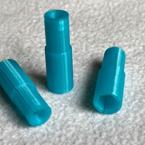 May include: Three turquoise blue plastic connectors with a hexagonal shape on one end and a round shape on the other end.