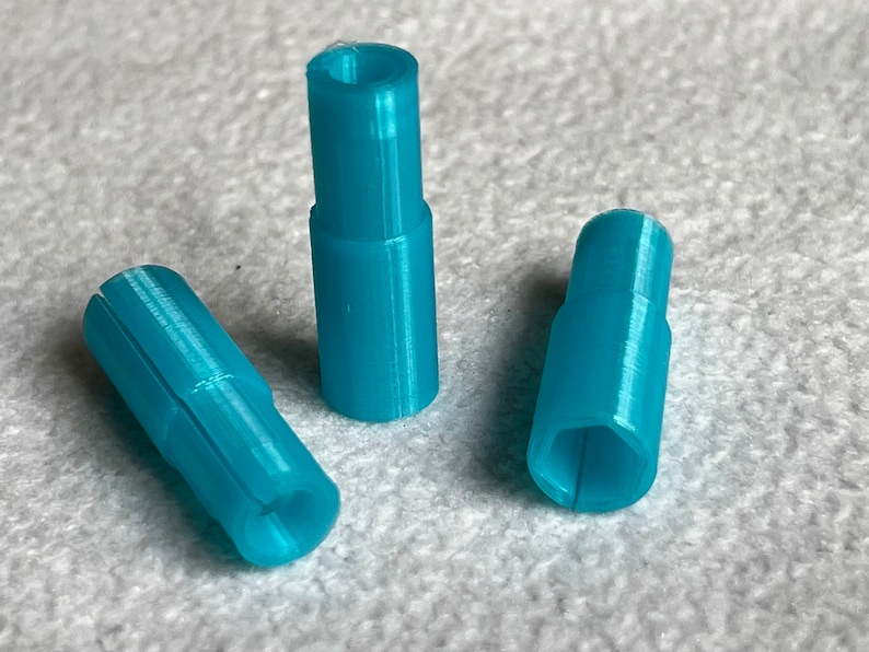 May include: Three turquoise blue plastic connectors with a hexagonal shape on one end and a round shape on the other end.