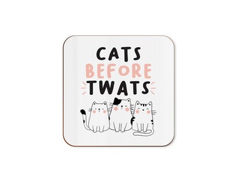May include: White coaster with black text that reads "Cats Before Twats" with three cartoon cats in black and white with pink cheeks.