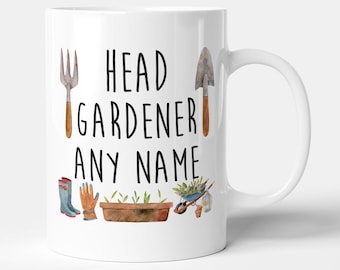 May include: White ceramic mug with a black and white design that says "Head Gardener [Name]" with gardening tools and plants illustrated around the text.