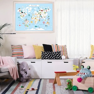 May include: A white, wooden storage bench with three drawers and a colorful striped rug in front of it. There are several colorful pillows on the bench, including a pink, a yellow, and a black and white polka dot pillow. A stuffed elephant sits on the floor next to the bench. A world map with animals and landmarks is hanging on the wall behind the bench.