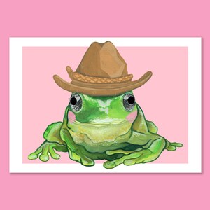 Cute blushing frog wearing a cowboy hat. Yeehaw howdy cowboy frog. Frog painting by Emily Peet Illustration. Frog in hat, funny art.