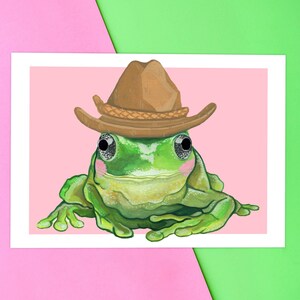 Cute blushing frog wearing a cowboy hat. Yeehaw howdy cowboy frog. Frog painting by Emily Peet Illustration. Frog in hat, funny art.