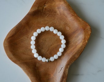 8mm White Jade Crystals with a 925 Sterling Silver bead accent on an elastic bracelet