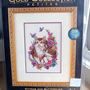 May include: A counted cross stitch kit titled Kittens and Butterflies by The Gold Collection Petites. The package features a design of two kittens surrounded by colourful flowers and butterflies, with a finished size of 13 cm by 18 cm.