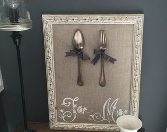 Silver cutlery on linen hand-painted initials in old-fashioned patinated frames