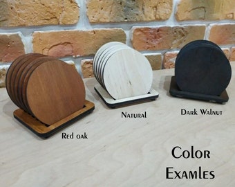 May include: Three sets of round wooden coasters in different wood stains. The coasters are stacked and displayed on a small wooden stand. The wood stains are red oak, natural, and dark walnut. The text "Color Examples" is displayed below the coasters.