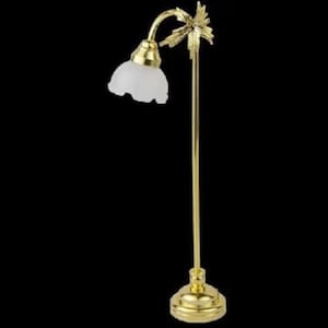 May include: A gold floor lamp with a white glass shade and a palm tree design. The lamp has a curved arm and a round base.