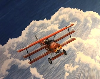 May include: A bright red triplane with black cross insignias on the wings and fuselage, featuring a yellow propeller and a pilot in the cockpit, flying through a sky filled with large, white, textured clouds against a deep blue background.