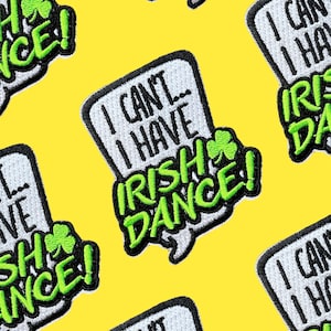May include: A set of four iron-on patches with a white background and black text. The patches feature the text "I can't... I have Irish Dance!" with a green shamrock.