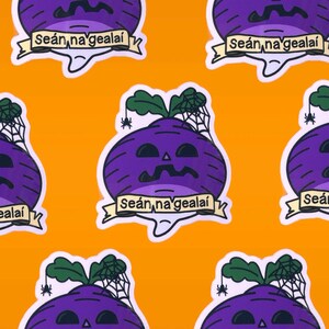 May include: Five purple turnip stickers with a jack-o'-lantern face, a green stem, and a spider web on top. Each sticker has a white banner with the text "Seán na gcealai" in black.