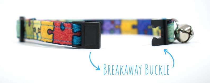 May include: A colourful cat collar with a jigsaw puzzle pattern and a breakaway buckle. The collar has a bell attached.