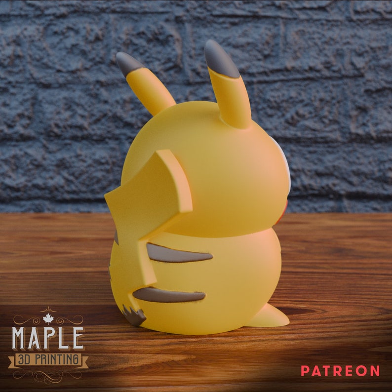 May include: A yellow Pikachu figurine with black ears and brown stripes on its back. The figurine is sitting on a wooden surface.