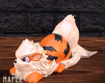 May include: A 3D printed figurine of a white and orange Pokemon with black stripes. The Pokemon is lying on its side with its tail curled up. The figurine is made of a smooth, glossy plastic.