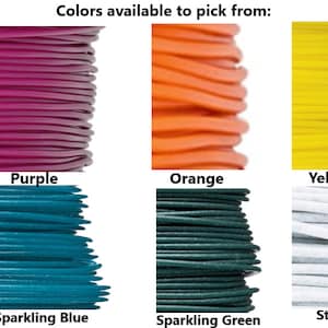 May include: A selection of colorful cords for crafting, including black, purple, orange, yellow, white, sparkling red, sparkling blue, sparkling green, stone, and sparkling yellow.