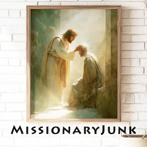 May include: Framed print of a religious scene. A figure in white robes places a hand on the head of a seated man. The artwork has a soft, ethereal quality with warm lighting. The text "MISSIONARYJUNK" is printed at the bottom.