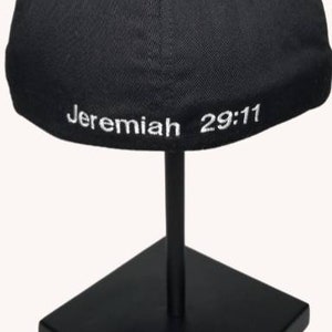 May include: Black baseball cap with white embroidered text "Jeremiah 29:11" on the back.