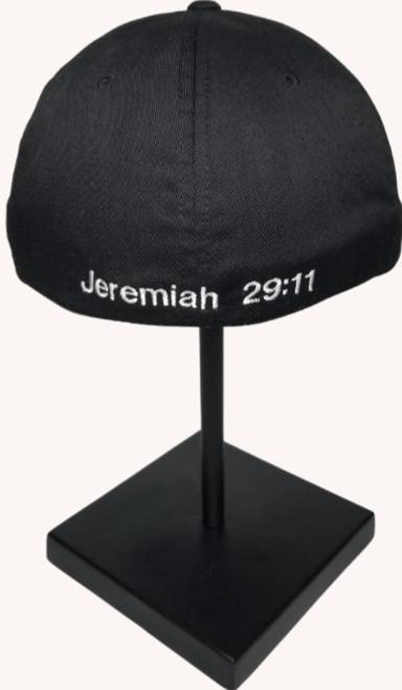 May include: Black baseball cap with white embroidered text "Jeremiah 29:11" on the back.