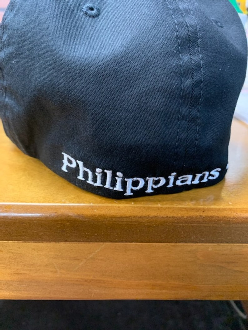 May include: Black baseball cap with white embroidery that reads "Philippians".