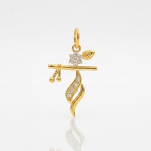 May include: A gold pendant shaped like a flute with a horizontal bar, a small leaf-like accent, and a flower motif. The piece features a series of small, clear, round-cut stones embedded along the curved lower section and the central flower.