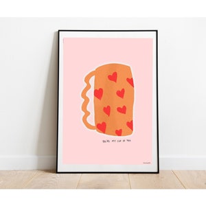 May include: A pink poster featuring a brown mug with red hearts. The text on the poster reads "You're my cup of tea."
