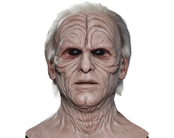 May include: A detailed, realistic mask of an elderly man with wrinkled skin and gray hair. The mask has a pale complexion and dark eyes.