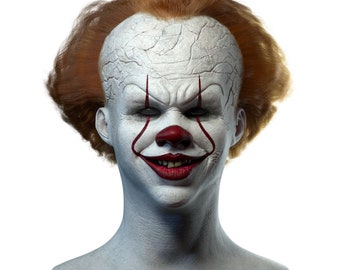 May include: A white clown mask with red painted lips and eyebrows. The mask has a creepy smile and red lines painted on the cheeks. The mask is on a black stand.