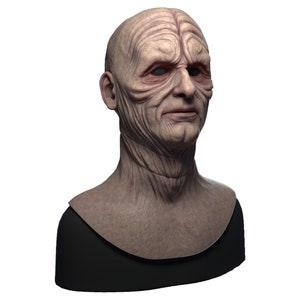 May include: A detailed bust sculpture of a humanoid figure with a wrinkled face and a bald head. The sculpture is made of a light brown material and is set against a white background.