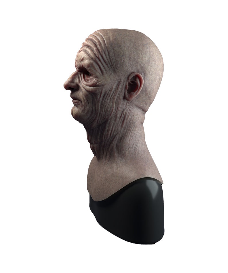 May include: A detailed bust sculpture of an elderly person's head and neck, with realistic wrinkles and skin texture. The bust is made of a light gray material and is mounted on a black base.