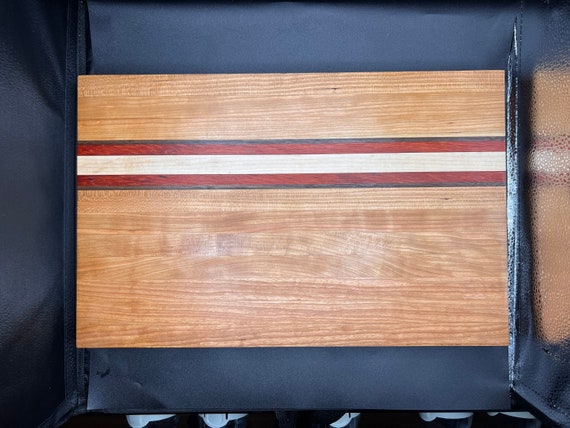 The Lincoln edge grain cutting board made from Cherry, Maple, Padauk, and Walnut Hardwood