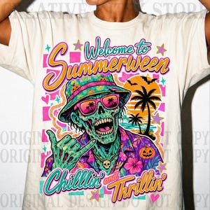 May include: A cream-colored t-shirt featuring a graphic of a green zombie wearing a bucket hat and pink sunglasses, making a shaka hand gesture. The text reads Welcome to Summerween and Chillin' and Thrillin' with palm trees and pumpkins.