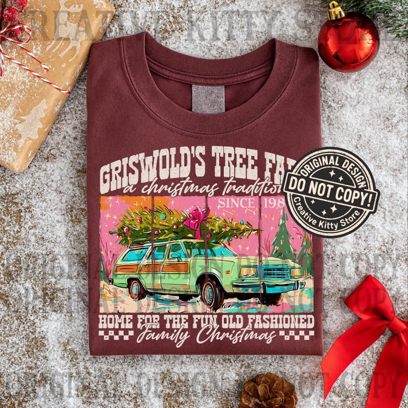 May include: Burgundy t-shirt with a graphic of a green station wagon carrying a Christmas tree. Text reads "Griswold's Tree Farm, a Christmas tradition since 1988, Home for the fun old fashioned family Christmas."