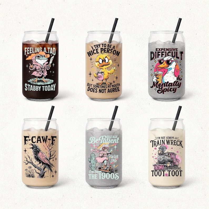 May include: Six glass tumblers with black straws, each featuring a unique design and text. The designs include a frog, a duck, a goose, a raven, a woman on a scooter, and a train. The text on the glasses reads "Feeling a Tad Stabby Today", "I Try to be a Nice Person", "Expensive Difficult Mentally Spicy", "F-Caw-F", "Be Patient With Me I'm from the 1900s", and "I'm Not Always a Train Wreck Toot Toot".