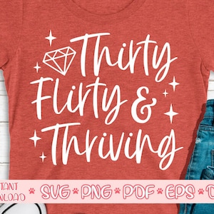 May include: Red t-shirt with white text that says "Thirty flirty & thriving" with a diamond graphic above the text.