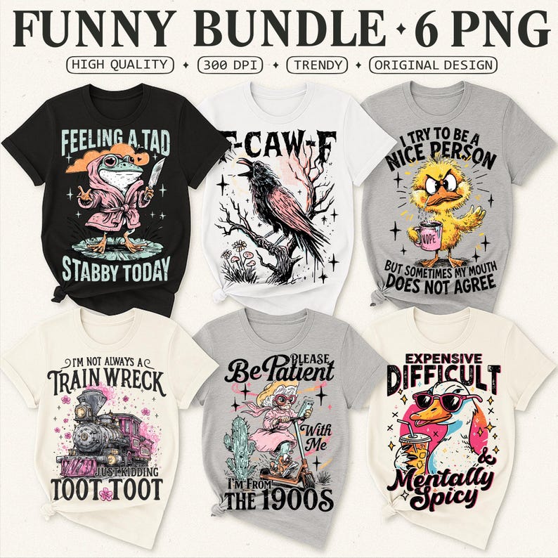 May include: A collection of six graphic t-shirts with humorous designs. The shirts feature various illustrations, including a frog with a knife, a crow, a duck, a train, a woman on a scooter, and a duck with sunglasses. Text includes "Feeling a Tad", "Stabby Today", and "Expensive Difficult".