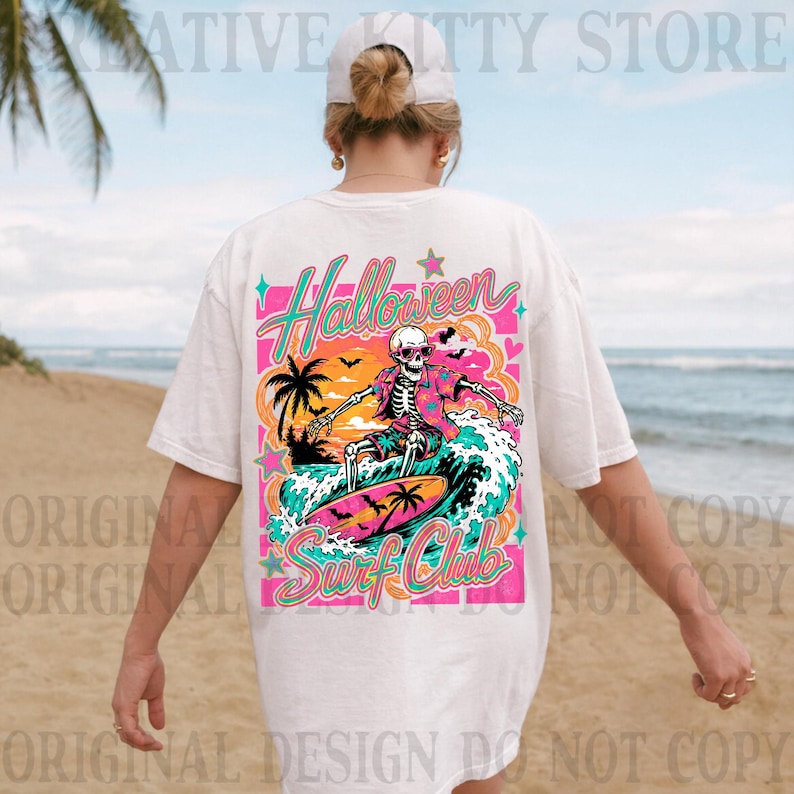 May include: A white t-shirt featuring a colorful graphic on the back. The design shows a skeleton wearing sunglasses and a floral shirt, surfing on a wave. The text reads Halloween Surf Club, surrounded by palm trees, bats, and stars.