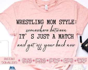 May include: Pink t-shirt with the text "WRESTLING MOM STYLE: somewhere between IT'S JUST A MATCH and get off your back now".