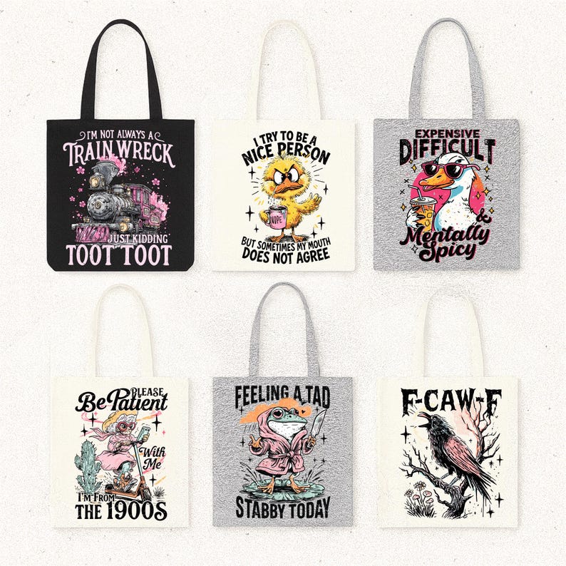 May include: Collection of tote bags with humorous designs. One bag is black with a train graphic and the text "I'm not always a train wreck." Other bags feature a duck, frog, and raven with witty phrases like "Mentally Spicy" and "Stabby Today."