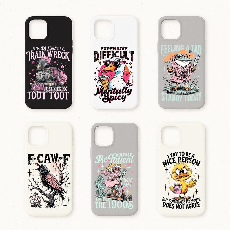 May include: A collection of six phone cases with humorous designs. The cases feature illustrations of a train, a duck with sunglasses, a frog in a robe, a raven, a woman on a scooter, and a chick. Each case has a unique phrase.