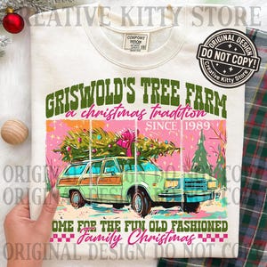 May include: Cream-colored sweatshirt featuring a graphic of a green station wagon carrying a Christmas tree, with text that reads "Griswold's Tree Farm" and "Family Christmas." The design includes pink and green accents, and the text "Since 1989."