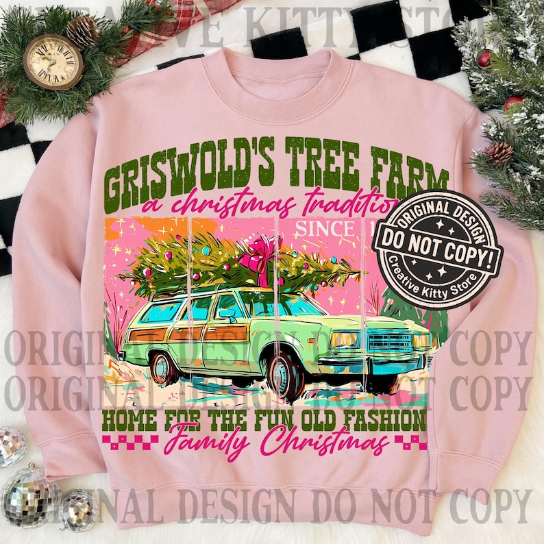 May include: Pink sweatshirt with a graphic of a green station wagon carrying a Christmas tree. Text reads "Griswold's Tree Farm, a Christmas tradition, Home for the fun old fashion family Christmas."