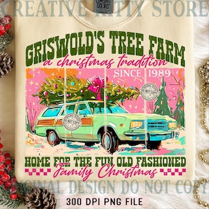 May include: Cream-colored sweatshirt with a graphic featuring a green station wagon carrying a Christmas tree. Text includes "Griswold's Tree Farm" and "Family Christmas" in green and pink. The design is a vintage-style illustration.