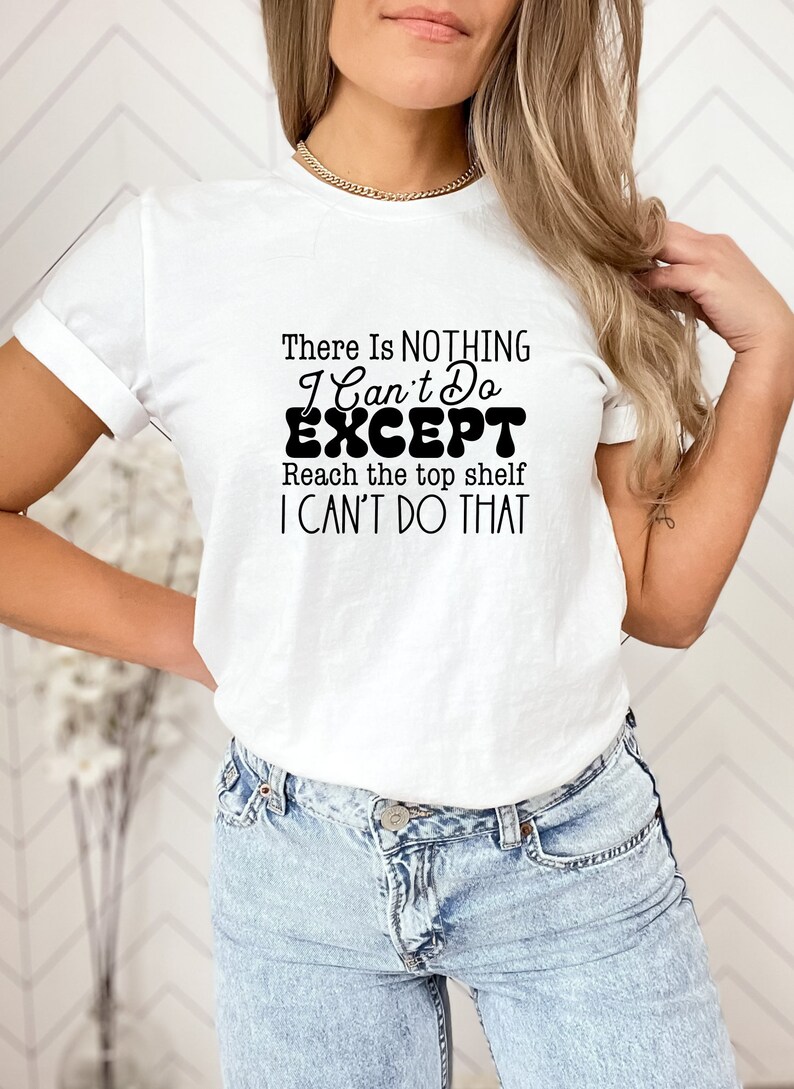 May include: White t-shirt with black text that reads "There is NOTHING I Can't Do EXCEPT Reach the top shelf I CAN'T DO THAT".