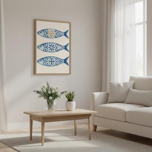 Blue tile sardine wall art framed above sofa, Portuguese azulejo fish print for coastal home decor.
