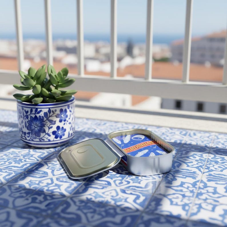 May include: An open tin of sardines with blue and white packaging, next to a small potted succulent in a blue and white floral ceramic pot. The scene is set on a blue and white tiled surface, with a city view in the background.